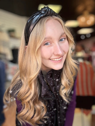 Black leather knotted headband worn on blonde hair