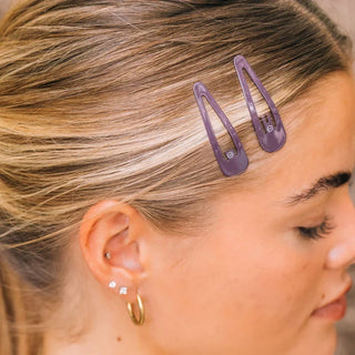 TELETIES Purple Haze snap clips holding a section of blonde hair