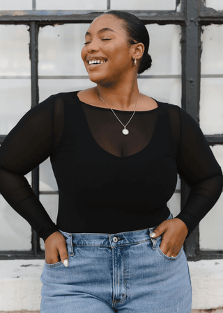 Black sheer long sleeve top with scoop neck and semi-sheer sleeves