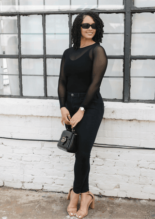 Black sheer long sleeve top with crew-to-scoop neckline and slim fit