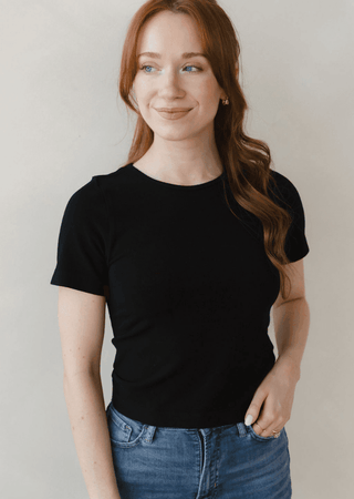 Black waist-length crewneck short-sleeve top, fitted at the waist