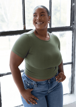 Women’s olive green short-sleeve waist-length top, fitted with crew neck