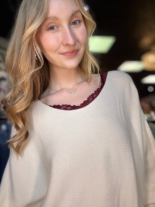 Cream dolman sleeve sweater with maroon lace-trim round neckline