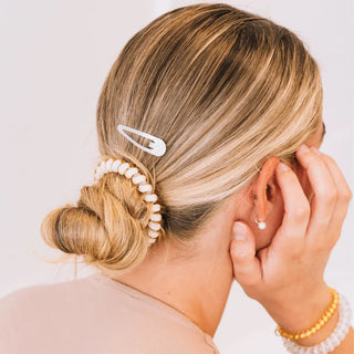 TELETIES Silver snap clips worn in a blonde updo