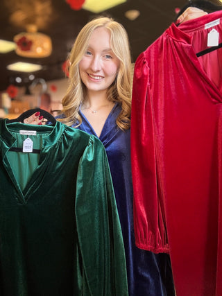Model in the Navy velvet balloon sleeve dress holding the Green and True Red colors, front view