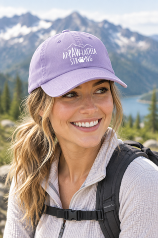 Woman wearing the lavender ApPAWlachia Strong baseball cap